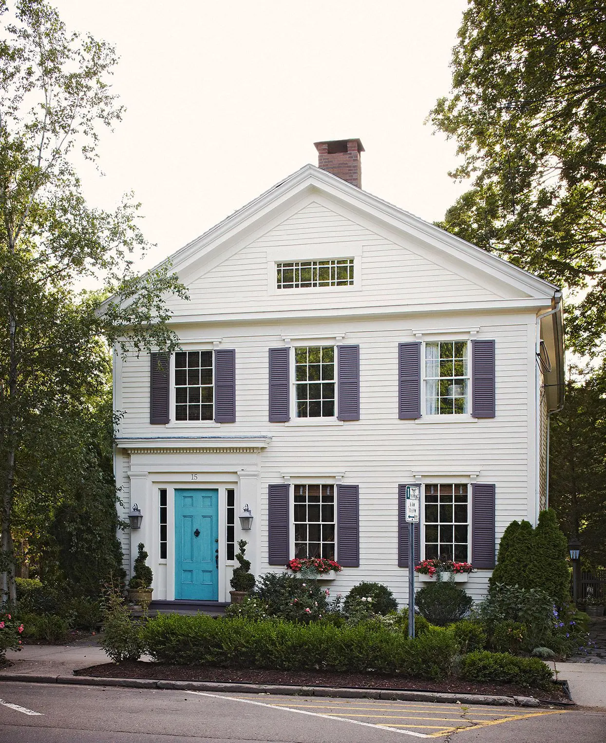 Front-facing colonial-style house with symmetrical windows and shutters