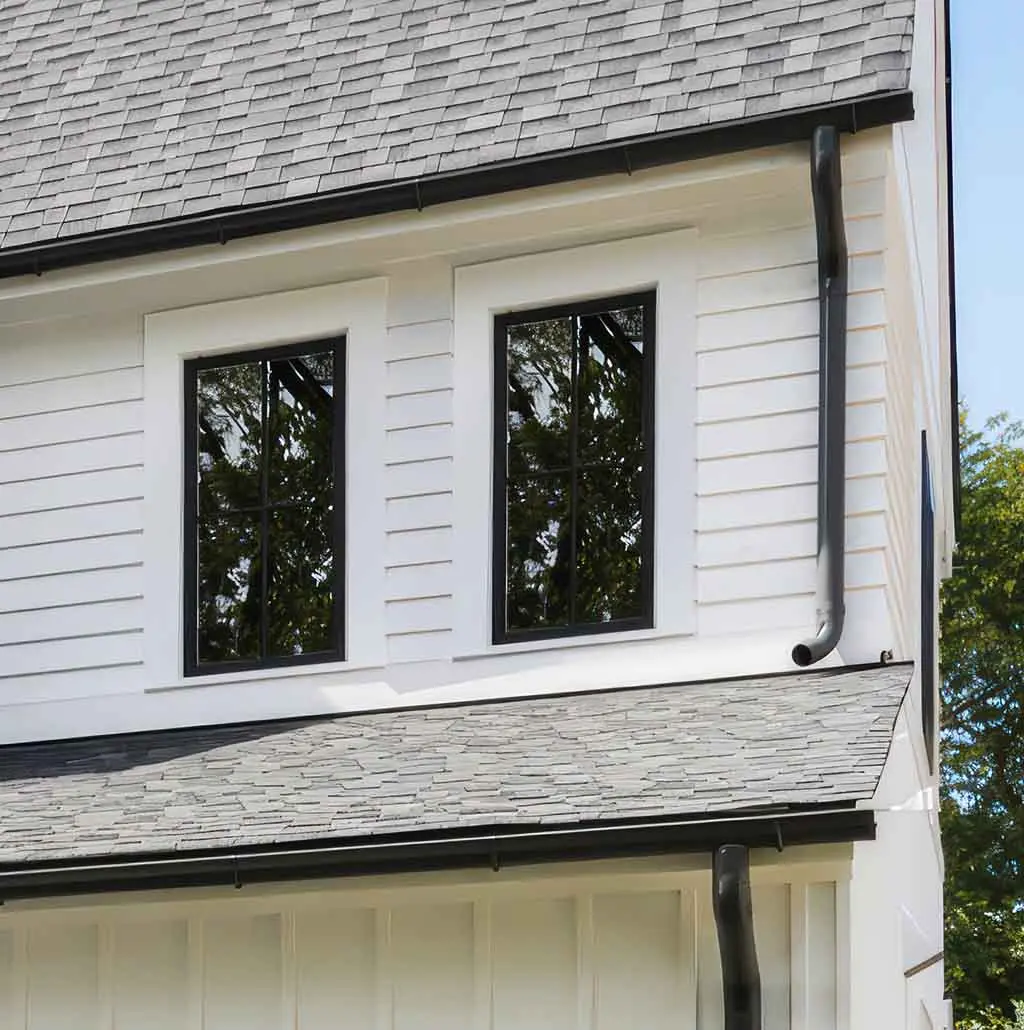Close-up reference of roof shingles, siding and guttering
