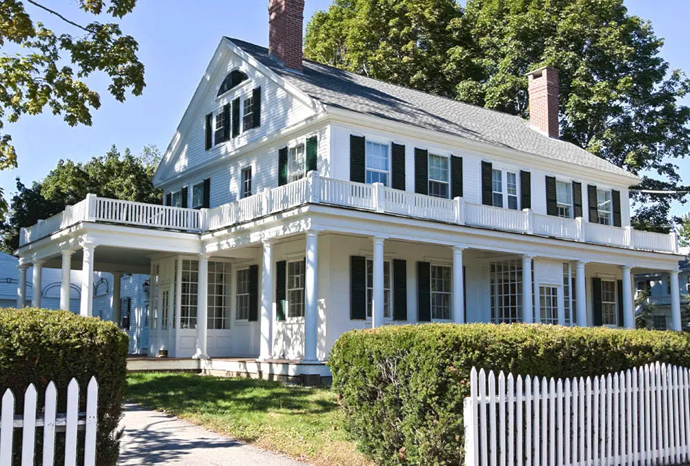 American house with a wraparound veranda and repeated columns